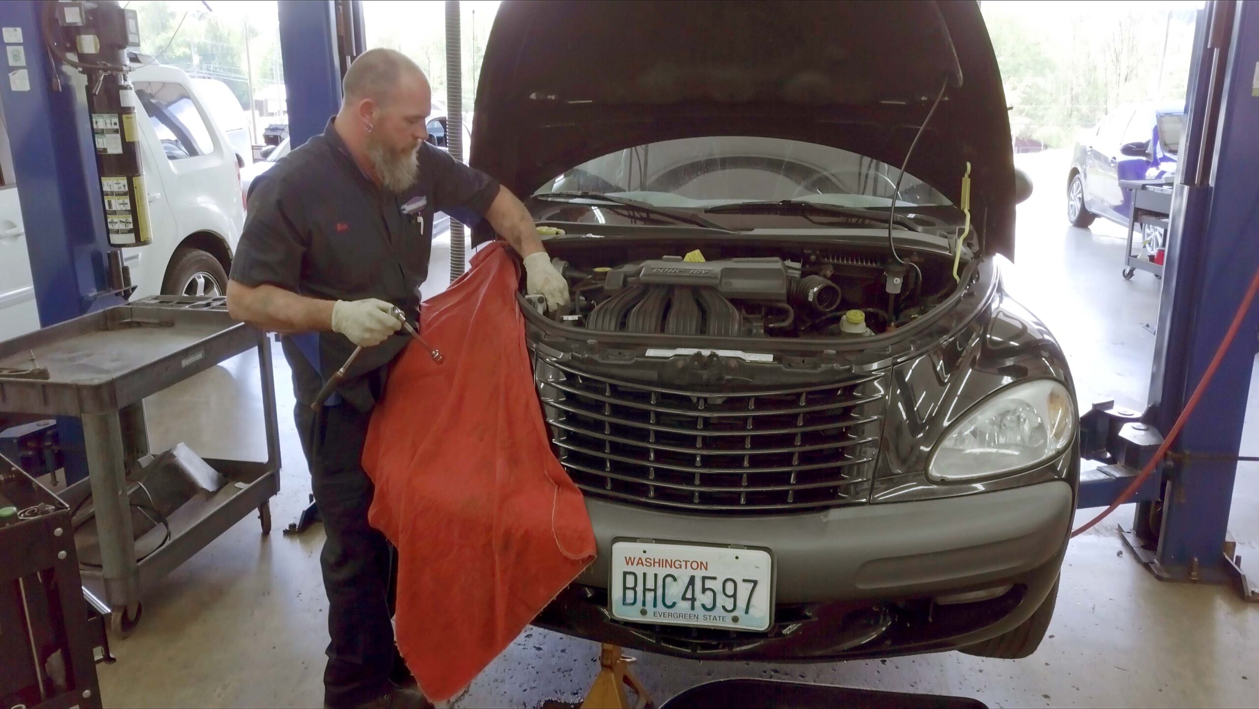 Auto repair technician servicing a domestic vehicle at Local Wrench Auto Repair in Belfair, WA