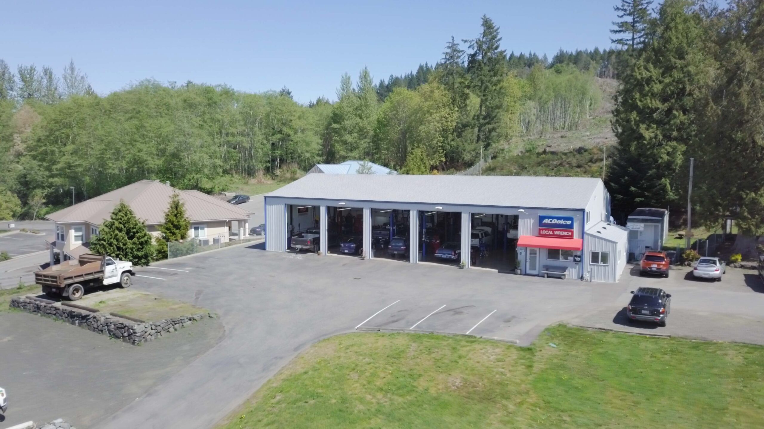 Aerial view of Local Wrench Auto Repair shop, parking lot, and property in Belfair, WA