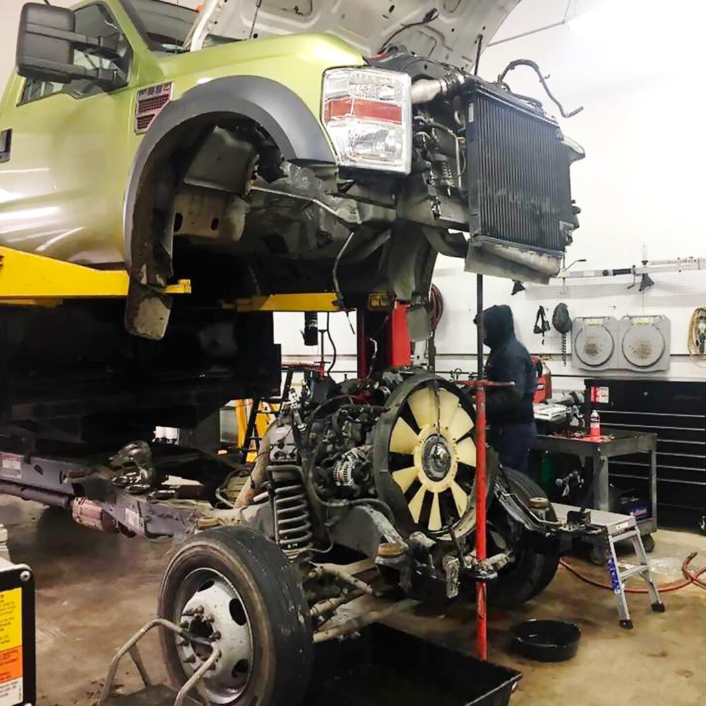 Diesel truck undergoing major drivetrain repair on a lift at Local Wrench Auto Repair in Belfair, WA