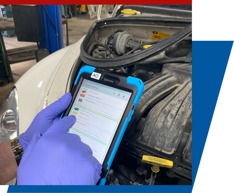 Mechanic reviewing digital vehicle inspection results on a tablet